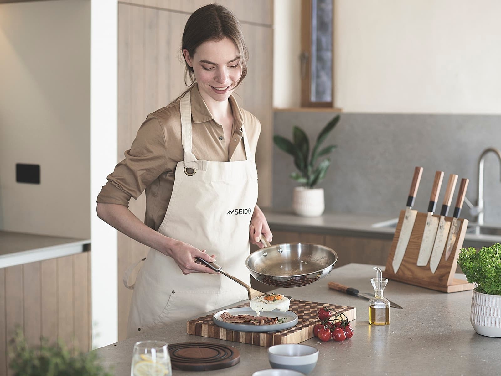 Cooking with an uncoated stainless steel skillet in a bright kitchen