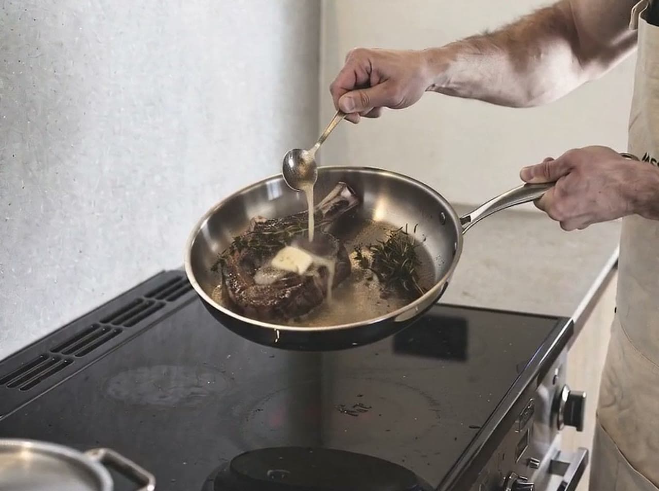 Steak searing in an uncoated stainless steel skillet