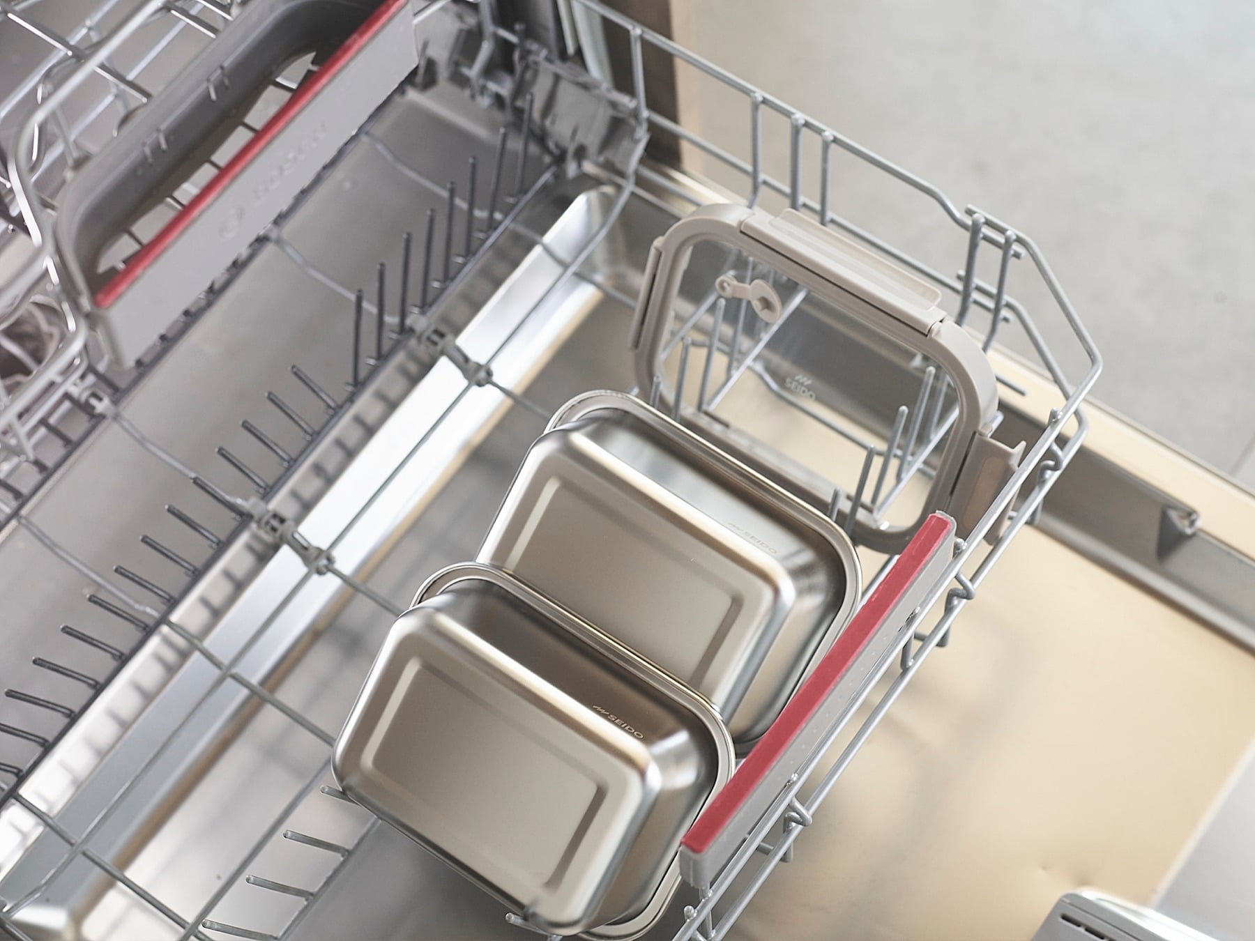 Stainless steel lunch boxes and lid in a dishwasher rack