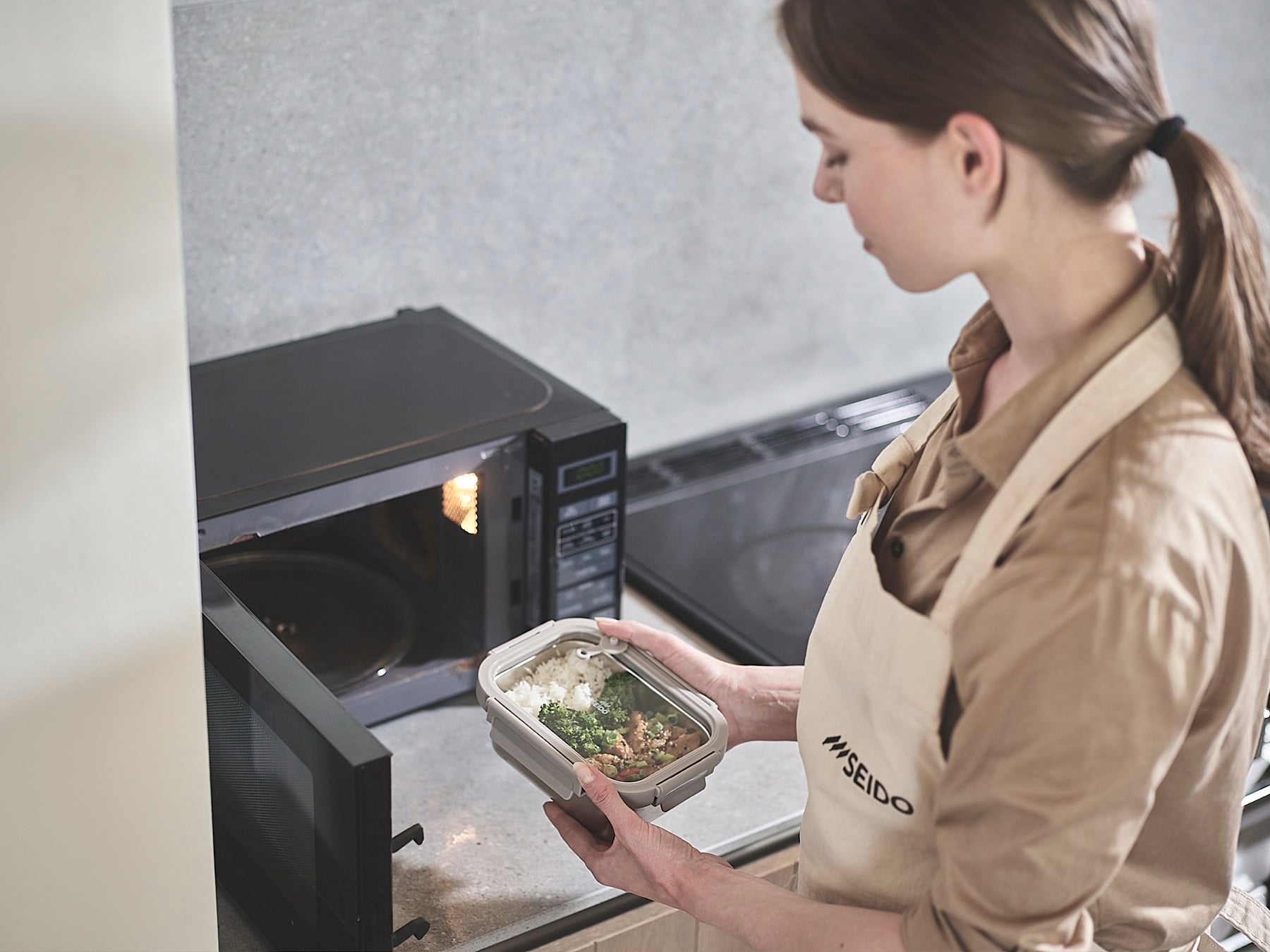 SEIDO stainless steel lunch box going into a microwave