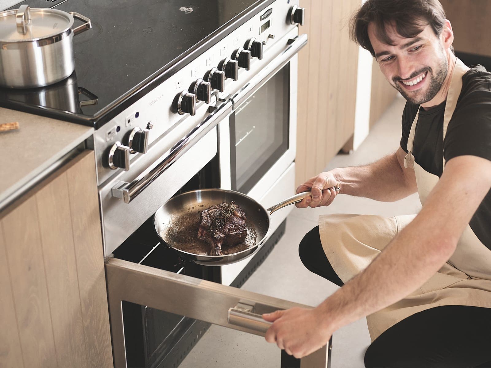 Taking a stainless steel skillet out of the oven