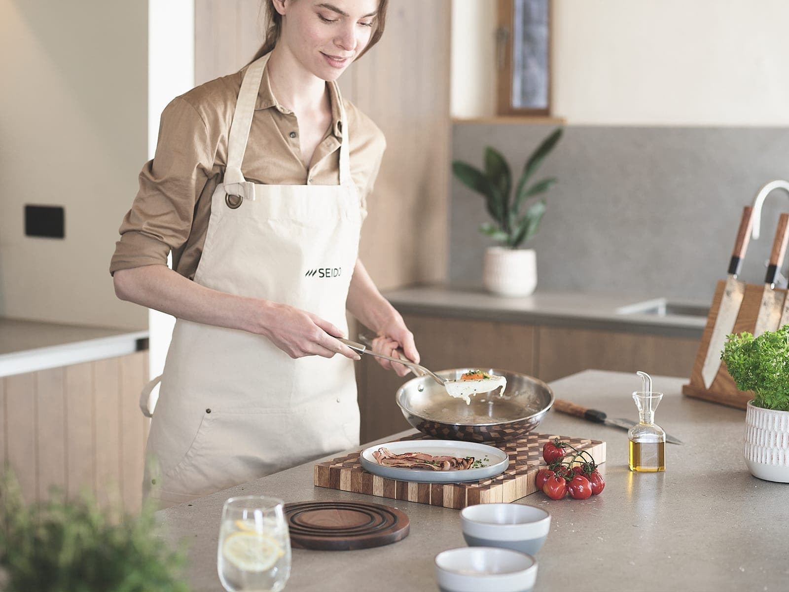 Plating a meal straight from an uncoated stainless steel skillet in a bright kitchen